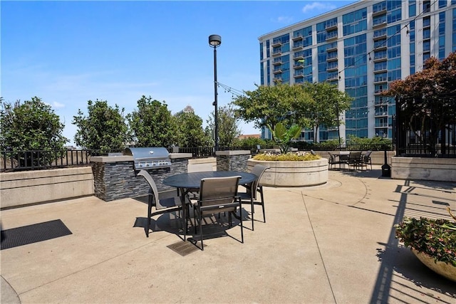 view of patio featuring outdoor dining area, area for grilling, and fence