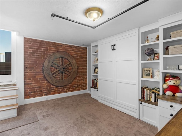 interior space with brick wall and light colored carpet