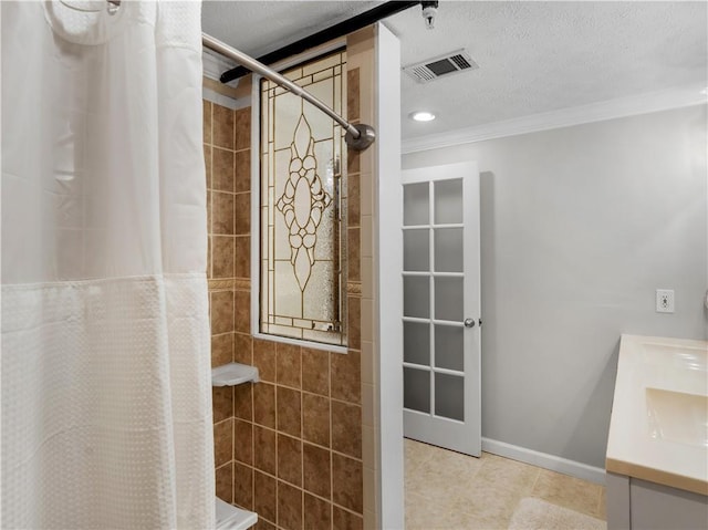 full bathroom featuring visible vents, a tile shower, vanity, and tile patterned floors