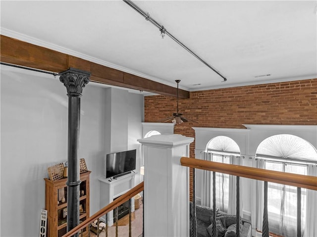 interior space with brick wall and an upstairs landing