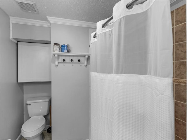 bathroom with ornamental molding, a shower with curtain, visible vents, and a textured ceiling