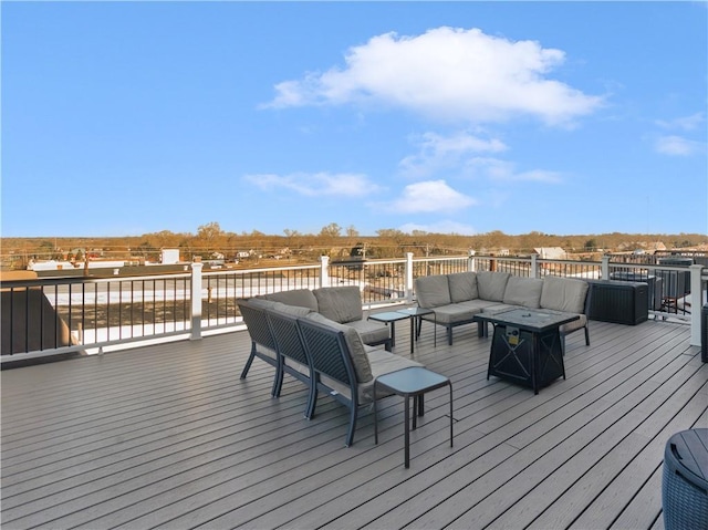 wooden terrace with an outdoor living space with a fire pit and central AC