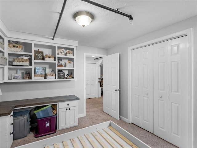 interior space featuring light colored carpet and baseboards