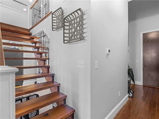 stairs with wood-type flooring and baseboards