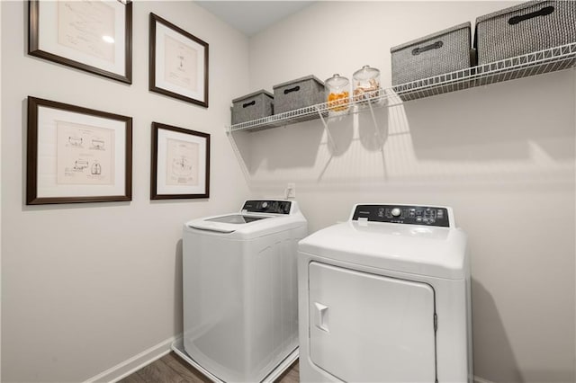 washroom featuring dark wood-type flooring and independent washer and dryer