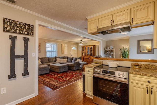 kitchen featuring crown molding, cream cabinetry, dark wood-type flooring, a textured ceiling, and stainless steel electric range