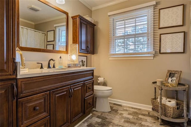 bathroom featuring vanity, toilet, and ornamental molding