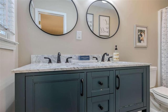 bathroom with toilet and vanity