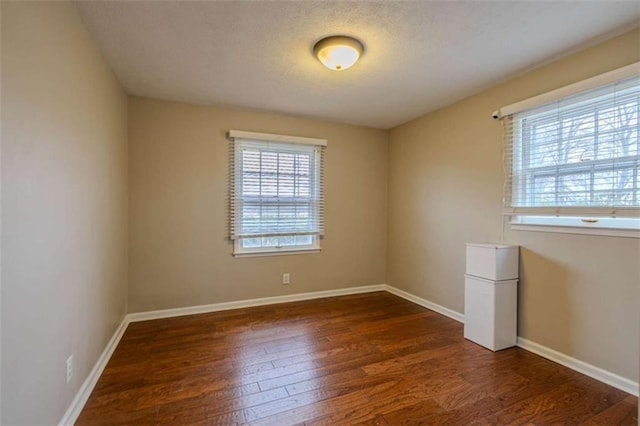 empty room featuring dark wood-type flooring