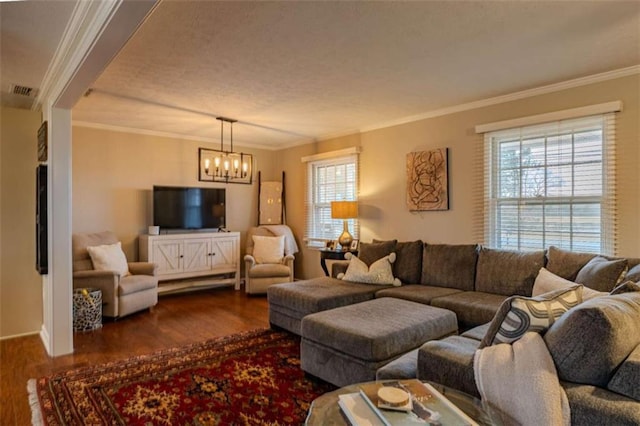 living room with crown molding, a healthy amount of sunlight, and dark hardwood / wood-style floors