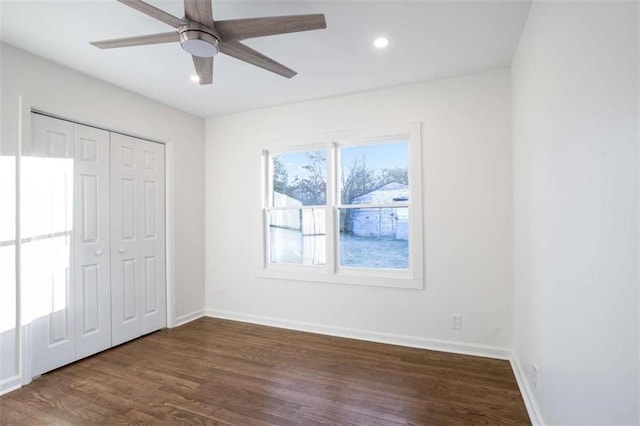 unfurnished bedroom featuring ceiling fan, a closet, and dark hardwood / wood-style floors