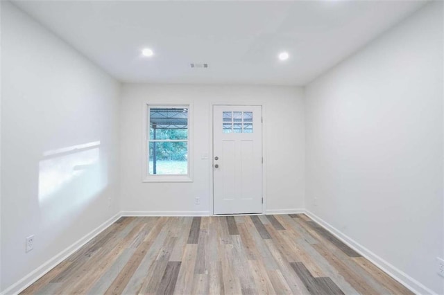 empty room with light hardwood / wood-style flooring