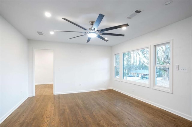 spare room featuring wood-type flooring and ceiling fan