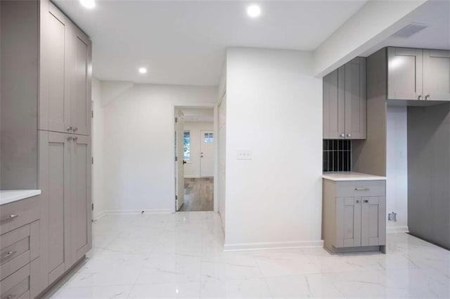 kitchen with backsplash and gray cabinetry