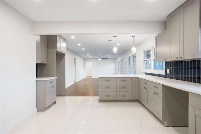 kitchen with backsplash and gray cabinetry