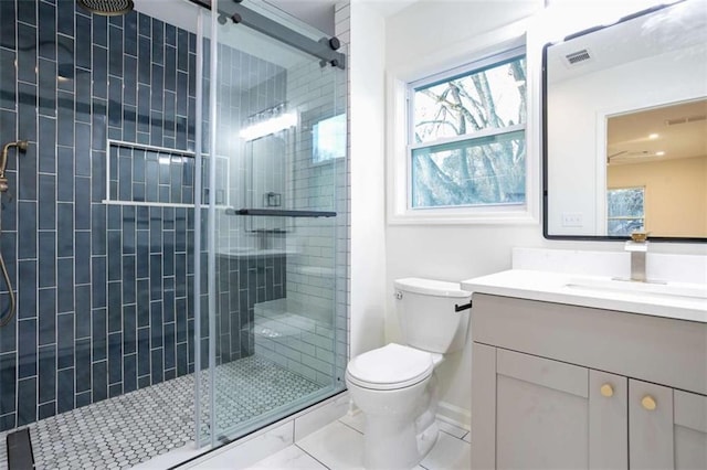 bathroom featuring walk in shower, plenty of natural light, vanity, and toilet