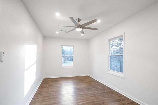 empty room with dark wood-type flooring and ceiling fan