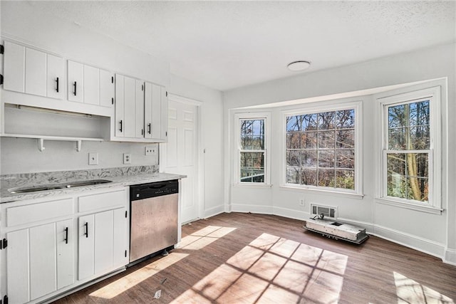7935 Sweetwater Dr, Douglasville, GA 30135 - kitchen with stainless steel dishwasher, open shelves, wood finished floors, white cabinets, and a textured ceiling