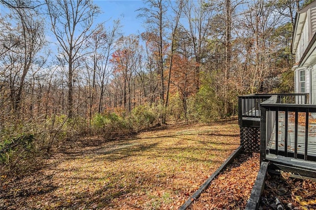 7935 Sweetwater Dr, Douglasville, GA 30135 - view of grassy yard with a wooden deck and a view of trees