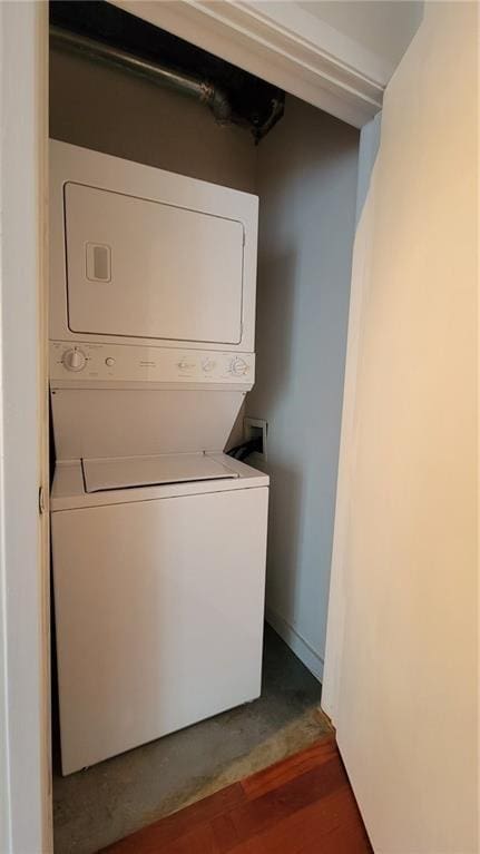 620 Glen Iris Dr NE Unit 321, Atlanta, GA 30308 - laundry room featuring estacked washer and dryer and wood finished floors