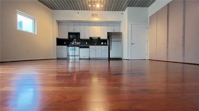 620 Glen Iris Dr NE Unit 321, Atlanta, GA 30308 - kitchen featuring freestanding refrigerator, electric stove, black microwave, dishwasher, and dark countertops
