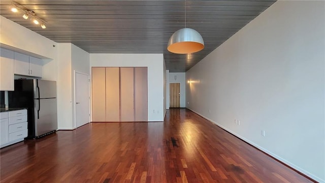 620 Glen Iris Dr NE Unit 321, Atlanta, GA 30308 - unfurnished living room with dark wood-style floors and baseboards