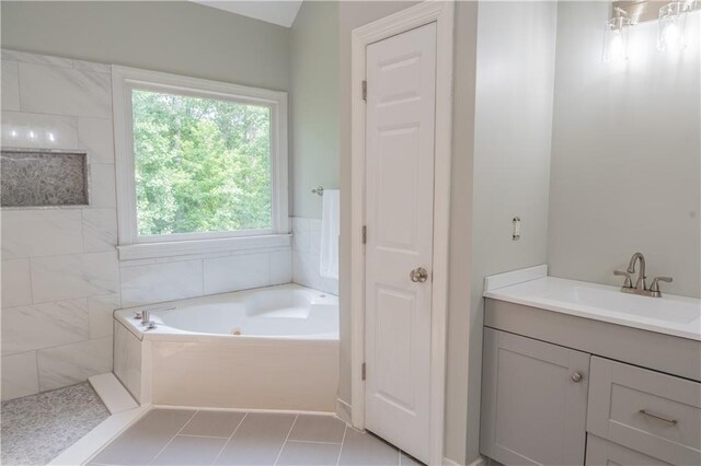 4569 Campenille Trce, Suwanee, GA 30024 - bathroom featuring a jetted tub, vanity, and tile patterned flooring