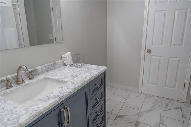 4569 Campenille Trce, Suwanee, GA 30024 - bathroom with vanity, marble look tiles, and a shower with shower curtain