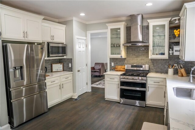 4569 Campenille Trce, Suwanee, GA 30024 - kitchen with stainless steel appliances, wall chimney exhaust hood, backsplash, dark wood-style flooring, and white cabinets
