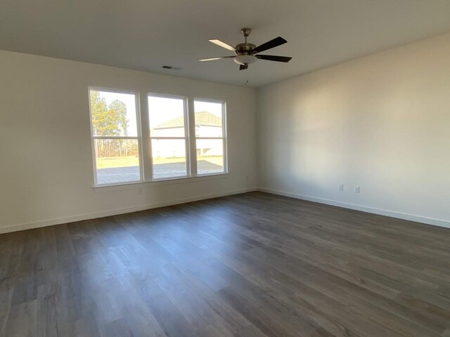 spare room featuring ceiling fan and dark hardwood / wood-style flooring