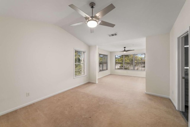 carpeted spare room featuring lofted ceiling and ceiling fan