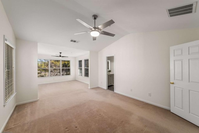 carpeted spare room featuring ceiling fan and lofted ceiling