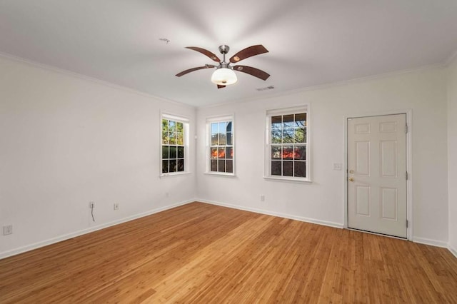 spare room featuring light hardwood / wood-style flooring, ceiling fan, plenty of natural light, and ornamental molding