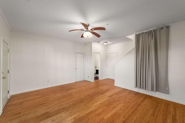 spare room featuring hardwood / wood-style floors, crown molding, and ceiling fan