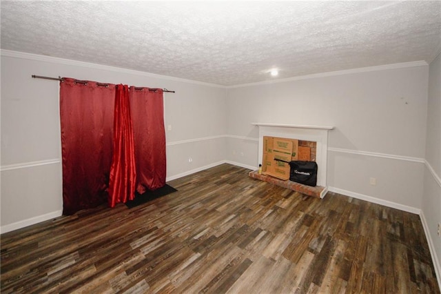 unfurnished living room featuring a textured ceiling, wood finished floors, baseboards, crown molding, and a fireplace