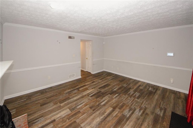 unfurnished room featuring wood finished floors, a textured ceiling, and baseboards