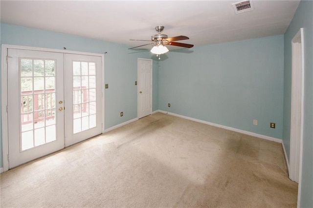 carpeted empty room featuring french doors, a ceiling fan, and baseboards