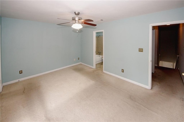 spare room with ceiling fan, light carpet, and baseboards