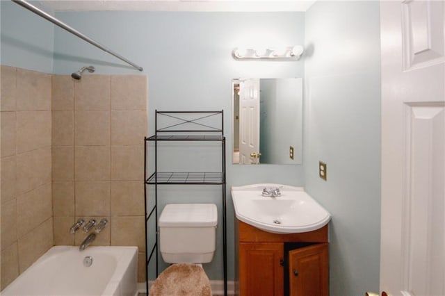 full bathroom featuring toilet, vanity, and bathtub / shower combination