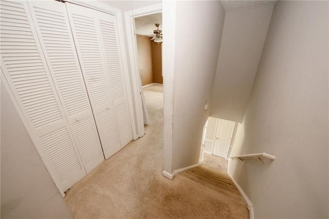 hallway with carpet flooring and baseboards