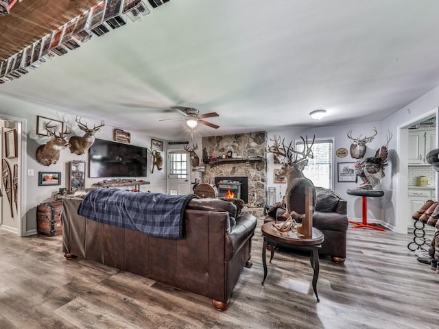 464 Mason Dr, Canton, GA 30115 - living room featuring plenty of natural light, a stone fireplace, wood finished floors, and a ceiling fan