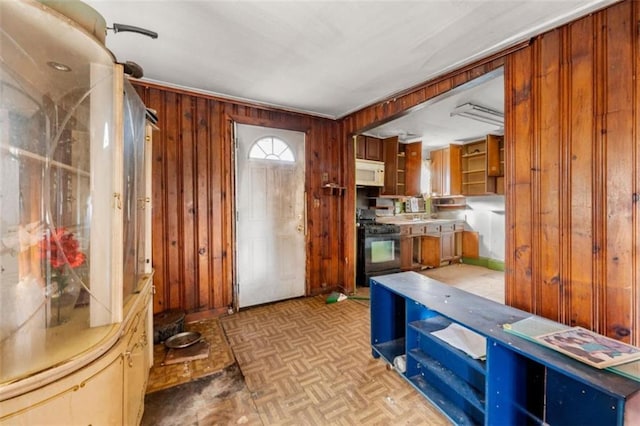 interior space featuring light parquet flooring and wood walls