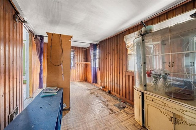 interior space featuring light parquet flooring and wood walls