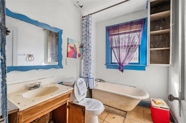 full bathroom featuring vanity, tile patterned floors, toilet, and shower / bath combo