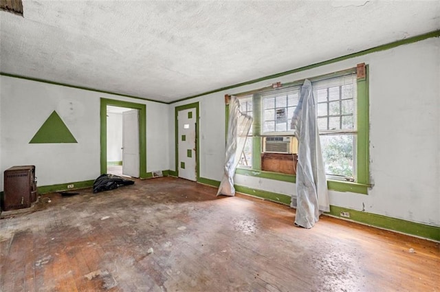 interior space featuring hardwood / wood-style floors, a textured ceiling, and cooling unit