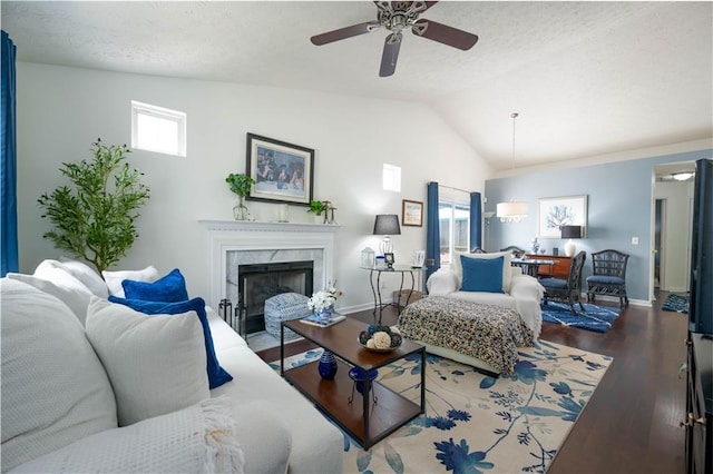 2305 Keenland Ct, Cumming, GA 30040 - living room featuring a ceiling fan, wood finished floors, lofted ceiling, baseboards, and a high end fireplace