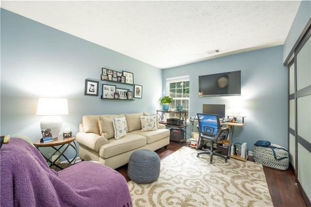 2305 Keenland Ct, Cumming, GA 30040 - living area with dark wood finished floors, a textured ceiling, and a desk