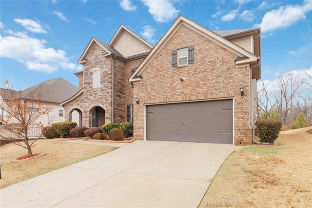 view of front of property with a garage and a front lawn