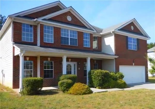 view of front facade featuring brick siding and an attached garage