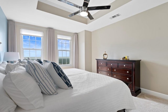 bedroom with carpet, a raised ceiling, baseboards, and ceiling fan